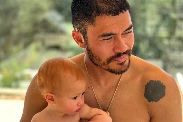Henry Golding Smiles with 11-Month-Old Daughter Florence as They Sit Together in Adorable Photo