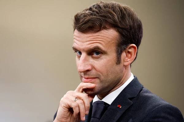 French President Emmanuel Macron looks on as he visits Chanel's Metiers d'Art workshops at le 19M, the building which houses around 600 artisans, in Paris, on January 20, 2022.