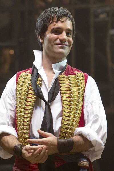 a man wearing a red and gold vest