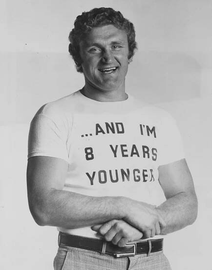 Black and white photo of Joe Bugner wearing a t-shirt that says 
