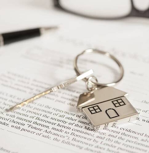 House document with keys and pen
