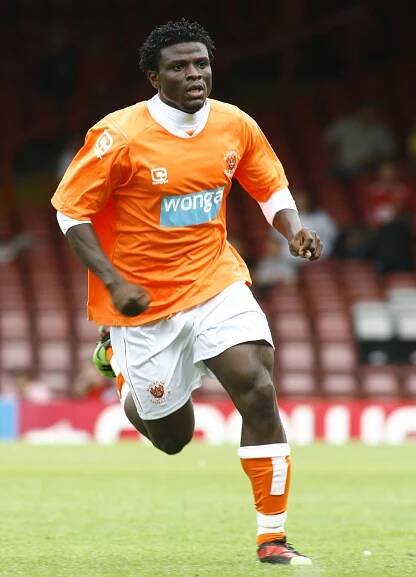 Razak Omotoyossi of Blackpool running on the soccer field.