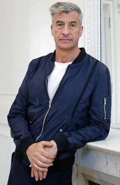Italian artist Maurizio Cattelan poses prior to the opening of the exhibition "Not Afraid of Love" at the Hotel de la Monnaie