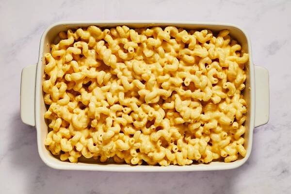cooked pasta with cheese sauce in baking dish