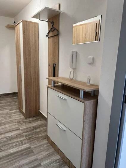 a kitchen with a counter and a phone on the wall at Apartmány Nová duha Vavřinec in Vavřinec