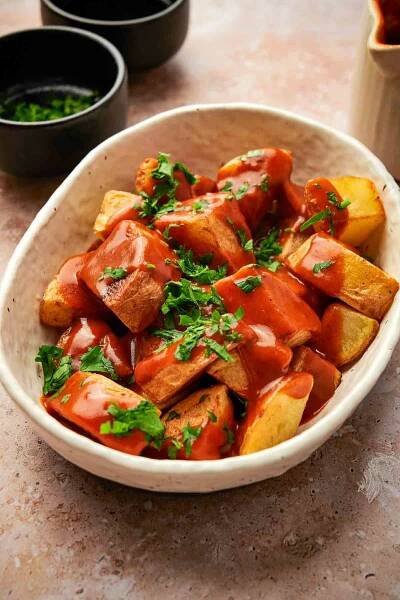 Fried potatoes covered in red bravas sauce.