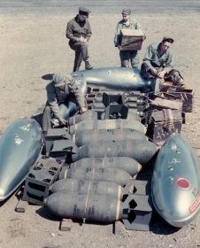 Ground crewmen at an Allied airfield await orders to begin arming a North American P-15 Mustang fighter for its next mission deep into Germany. The drop tanks, ammunition, and bombs may indicate that the Mustang will embark on a fighter-bomber sortie in support of Allied ground troops.