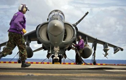 Aviation boatswain's mates refuel an AV-8B Harrier jet aircraft.