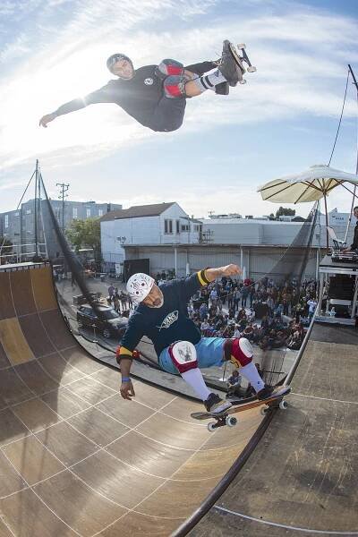 Elliot Sloan soars over Steve Caballero during a doubles routine. Photo: Joe Brook