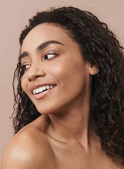 beautiful black woman with smooth skin looking over shoulder