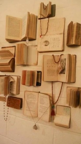 several open books are hanging on the wall