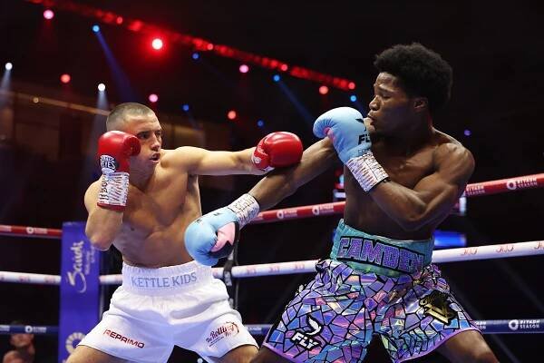 Nick Ball of Team Queensberry punches Raymond Ford of Team Matchroom during a boxing match.