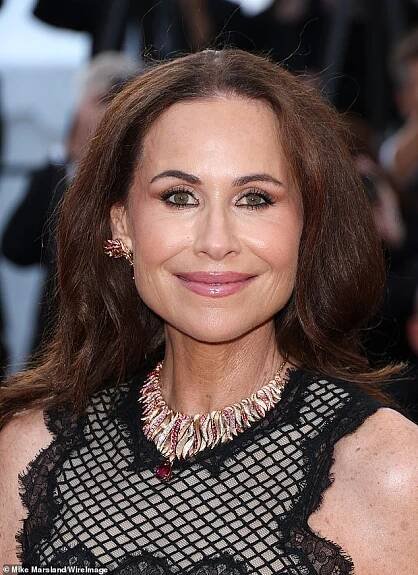 Minnie's chocolate brown locks were styled in voluminous coiffed waves and she accessorised with a huge diamond necklace