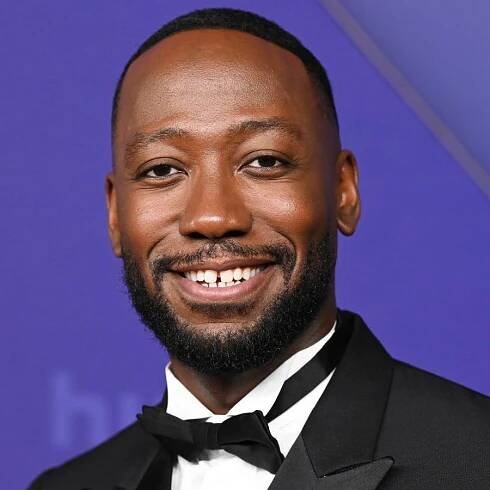 Lamorne Morris' pool features lush greenery, light patio furniture, and blue tiles for a Mediterranean style that...