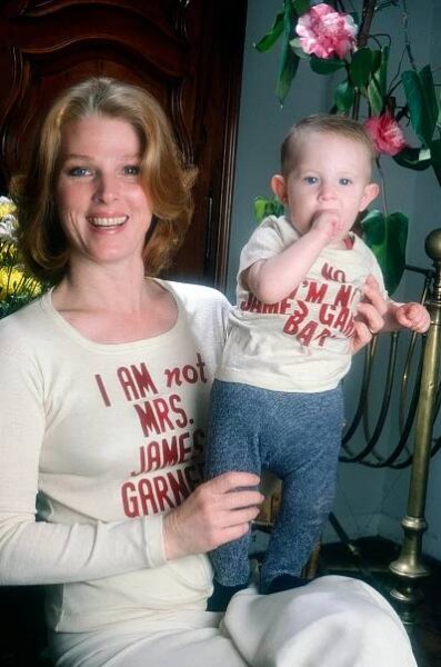 Mariette Hartley (left), who appeared a series of TV commercials for Polaroid with James Garner in the 1970s and 80s, causing many viewers to believe they were married in real life, wearing a T-shirt she had printed with the phrase, 'I am not Mrs. James Garner,' holding daughter Justine Boyriven, wearing a T-shirt Hartley printed with the phrase, 'I am not James Garner's baby,' 1979. 