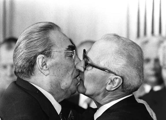 Soviet President Leonid Brezhnev and East German leader Erich Honecker change kisses after Brezhnev was honored with the title 