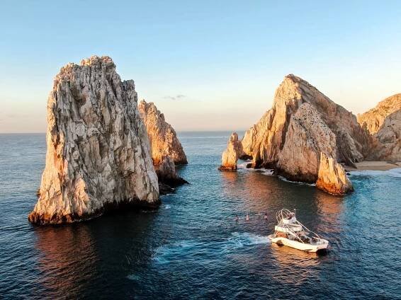 Paddle boarding near The Arch with the Pelican Cabo in tow