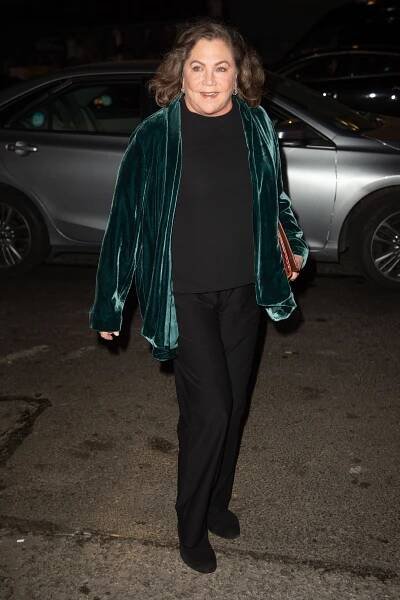 At the Women's Media Awards in New York City, Kathleen Turner wears a chic emerald green velvet jacket over an all-black ensemble, exuding sophistication as she arrived at the event.