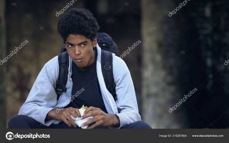Unhappy Male Teen Backpack Chewing Sandwich Snack Sitting Outdoors Street — Stock Photo © motortion #315267904