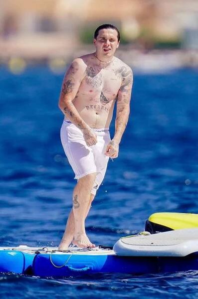 Internet Chef Brooklyn Beckham showed of his impressive range of body art and his physique in a revealing pair of Adidas swimming trunks whilst on vacation in Saint-Tropez, France