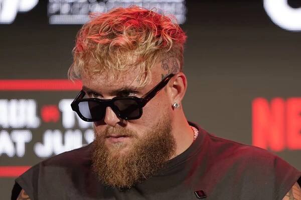 Jake Paul listens during a news conference promoting his upcoming fight against Mike Tyson