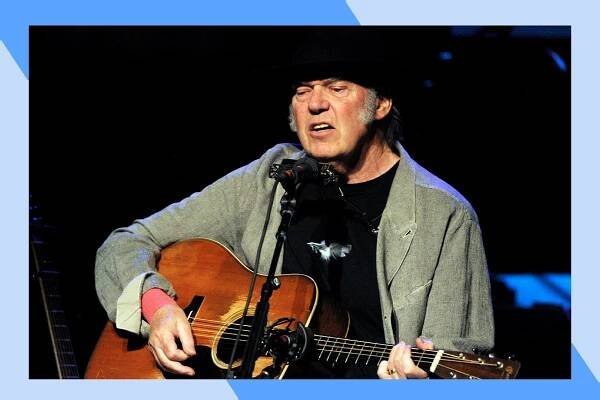 Neil Young sings and plays acoustic guitar in concert.