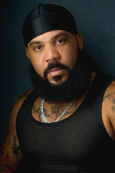 A professional photographer captures a headshot of a man with a beard and tattoos for Eric Campbell Photography in Fort Lauderdale.