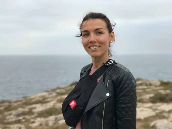 Portuguese woman is wearing a black jacket and smiling