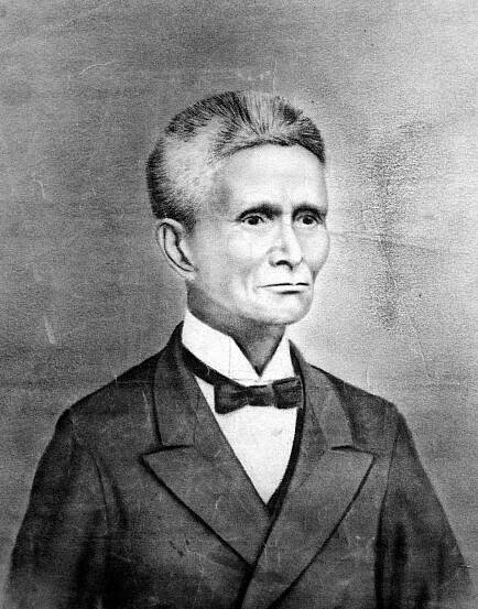 A black and white photo-realistic portrait of a senior Japanese man with bristly, salt and pepper hair, a slight smile, wearing a suit jacket, and a starched collar shirt tied with a bowtie.