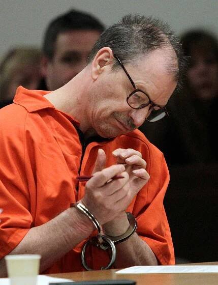 Green River Killer Gary Ridgway looks down at paperwork during his arraignment on charges of murder in the 1982 death of Rebecca "Becky" Marrero, Friday, Feb. 18, 2011, at the King County Regional Justice Center in Kent., Wash. Ridgway already confessed to killing Marrero as part of a 2003 plea deal that spared him the death penalty.