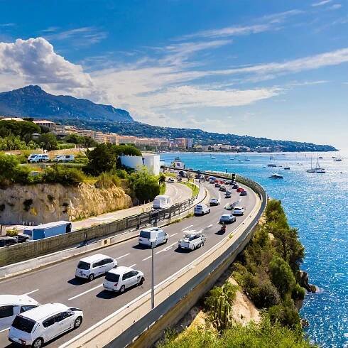 Firefly cars and campervans drinving on a motorway along the french riviera on a sunny day wide shot
