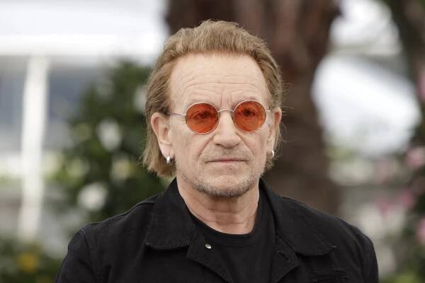 An image collage containing 1 images, Image 1 shows Bono at the photo call for the film "Bono: Stories of Surrender" at the Cannes Film Festival