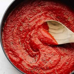Oil-free pizza sauce in a pan with a spoon. 