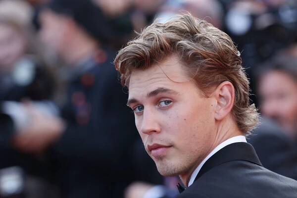 Image may contain Human Person Face Austin Butler Suit Coat Clothing Overcoat and Apparel