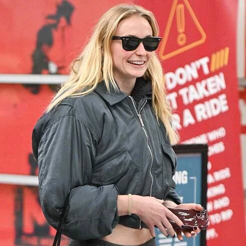 Sophie Turner is all smiles upon arriving at JFK airport in New York City. 