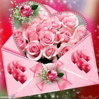an envelope with pink roses in the shape of a heart
