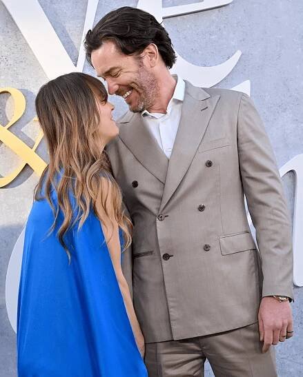 Kaley Cuoco blue dress Tom Pelphrey tan suit