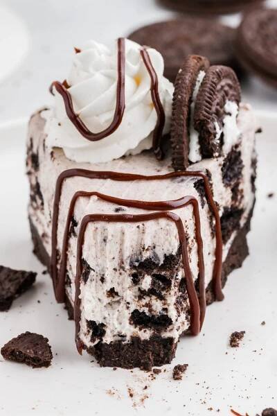 A front photo of a slice of the finished no bake Oreo cheesecake showing a bite taken out.
