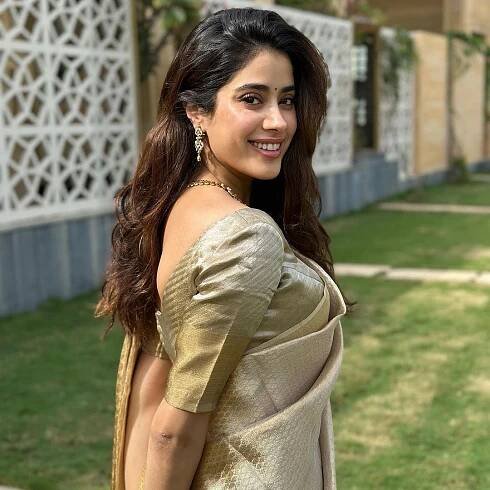 Janhvi Kapoor in a golden Kanchipuram silk sari stands as the quintessential festive look