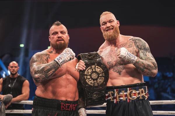Eddie Hall and Hafþór Björnsson holding a championship belt.