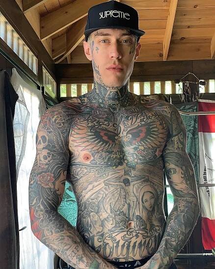a man with tattoos on his chest and arms