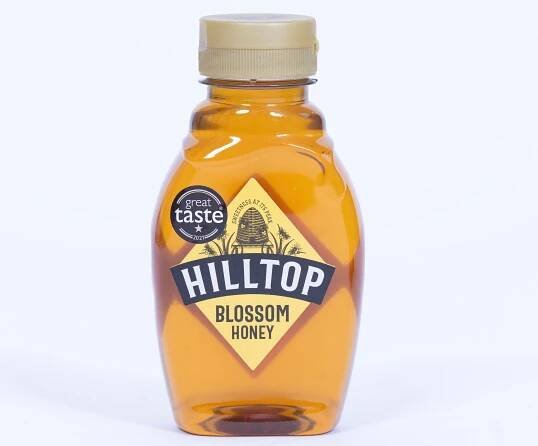 A bottle of Hilltop Blossom Honey with a "Great Taste 2021" award sticker.