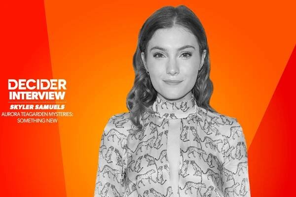 Skyler Samuels in black and white on a bright orange background