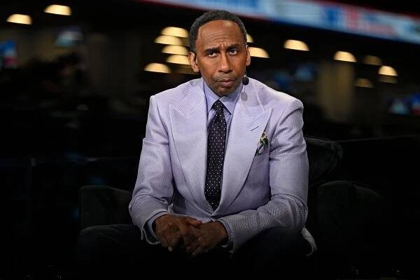 Stephen A. Smith in a suit looks ahead.