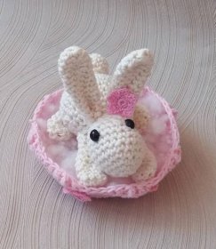 a crocheted stuffed animal in a pink bowl