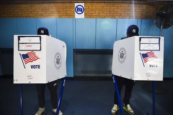 A father and son vote at a polling site in New York City on November 3.