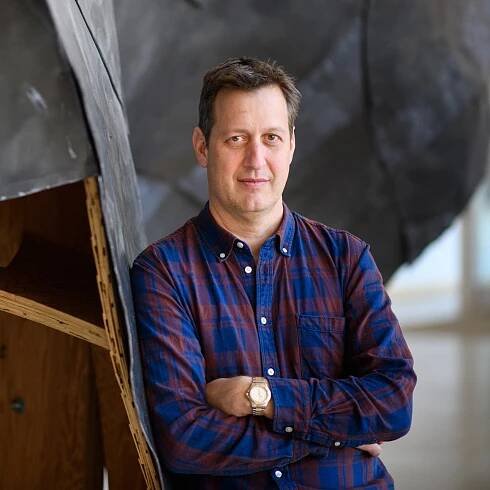 Jonathan Levine, with his arms crossed. 