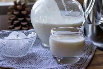 ayran is served in a pitcher or a glass with ice cubes