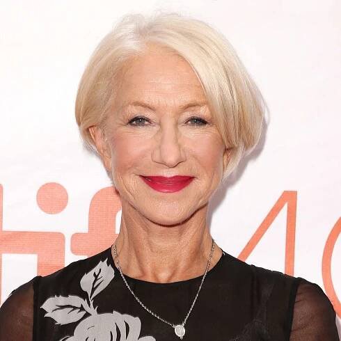 Helen Mirren voluminous sleek crop and red lip, blush, and subtle shimmery eye makeup