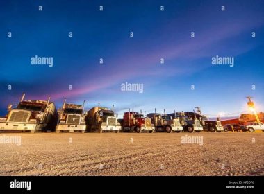 Truckstop Parked trucks at night Green River Utah truck stop rest area at night Stock Photo